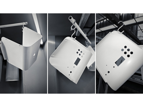 White powder-coated TESUP Atlas body panels and back covers hanging on hooks after coating