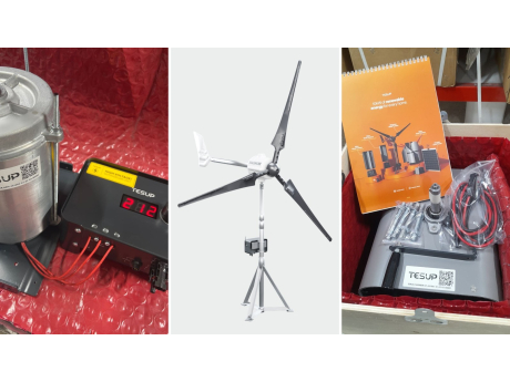 A TESUP permanent magnet motor/generator on the test bench wired to a TESUP charge controller, a TESUP Magnum wind turbine, and an Atlas body in its crate