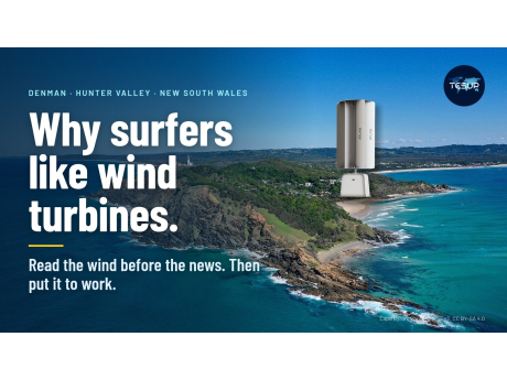 A TESUP Atlas vertical wind turbine on the green headland at Cape Byron, New South Wales, above a turquoise sea