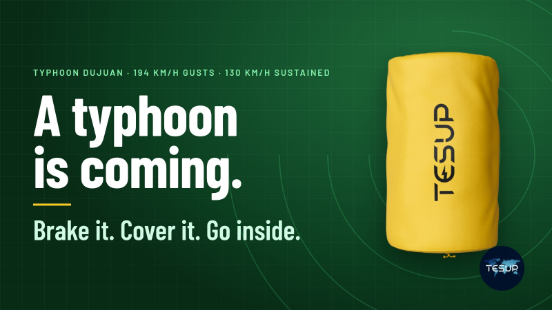 The bright yellow TESUP Atlas Protection Cover beside the words a typhoon is coming, brake it, cover it, go inside