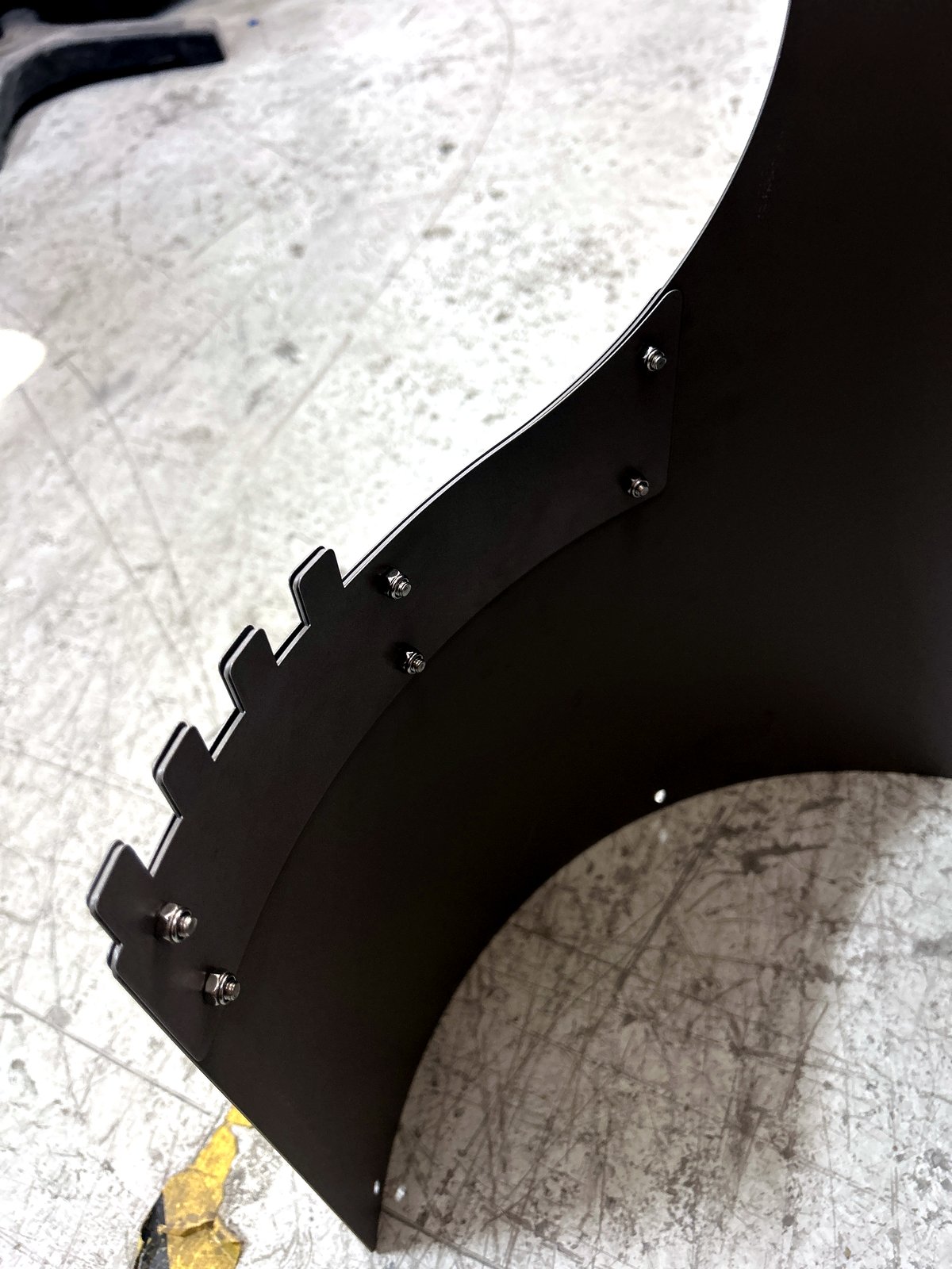 The reinforced blade root — stainless-steel plate, bolted by hand.