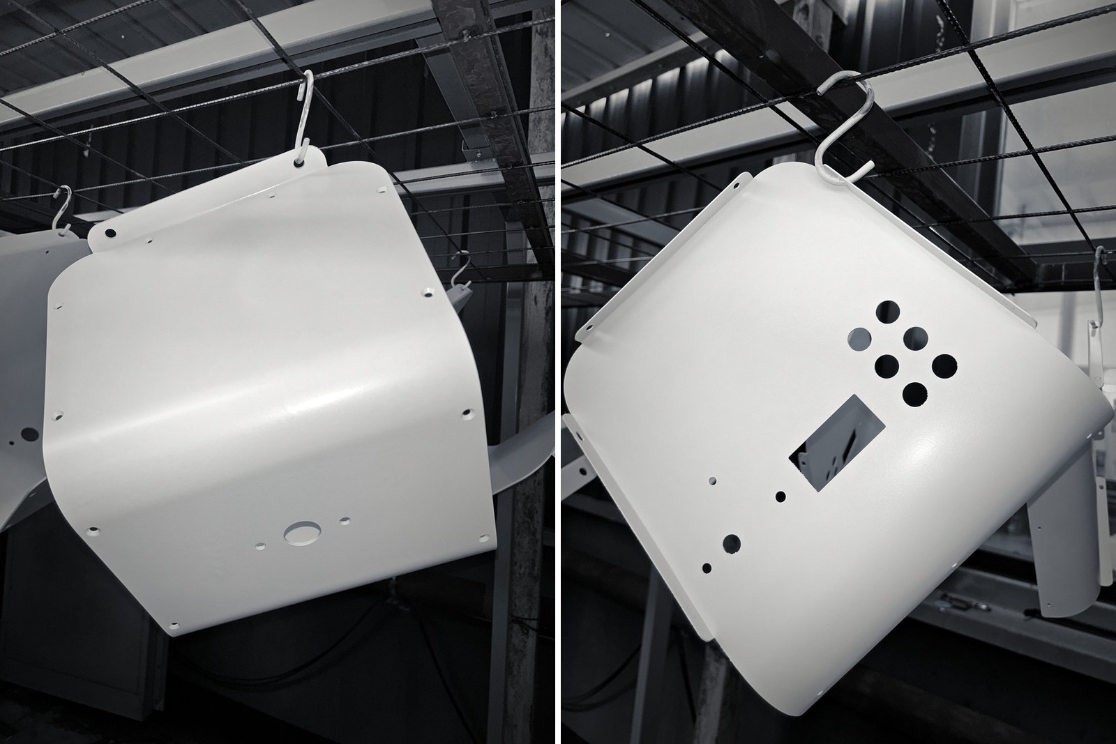 White powder-coated Atlas panels hanging on a rack