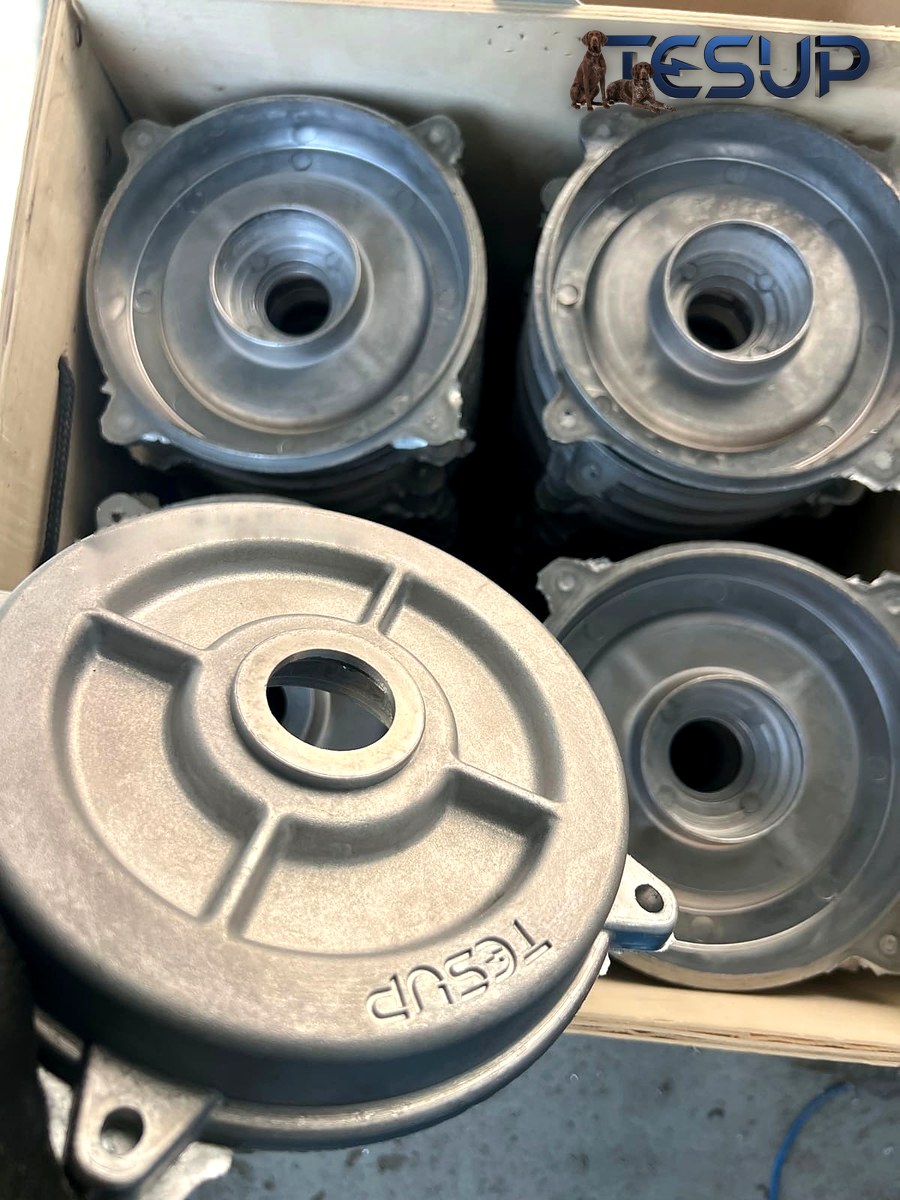 A box of raw cast aluminium covers, with the TESUP name cast into the top cover and casting edges still visible