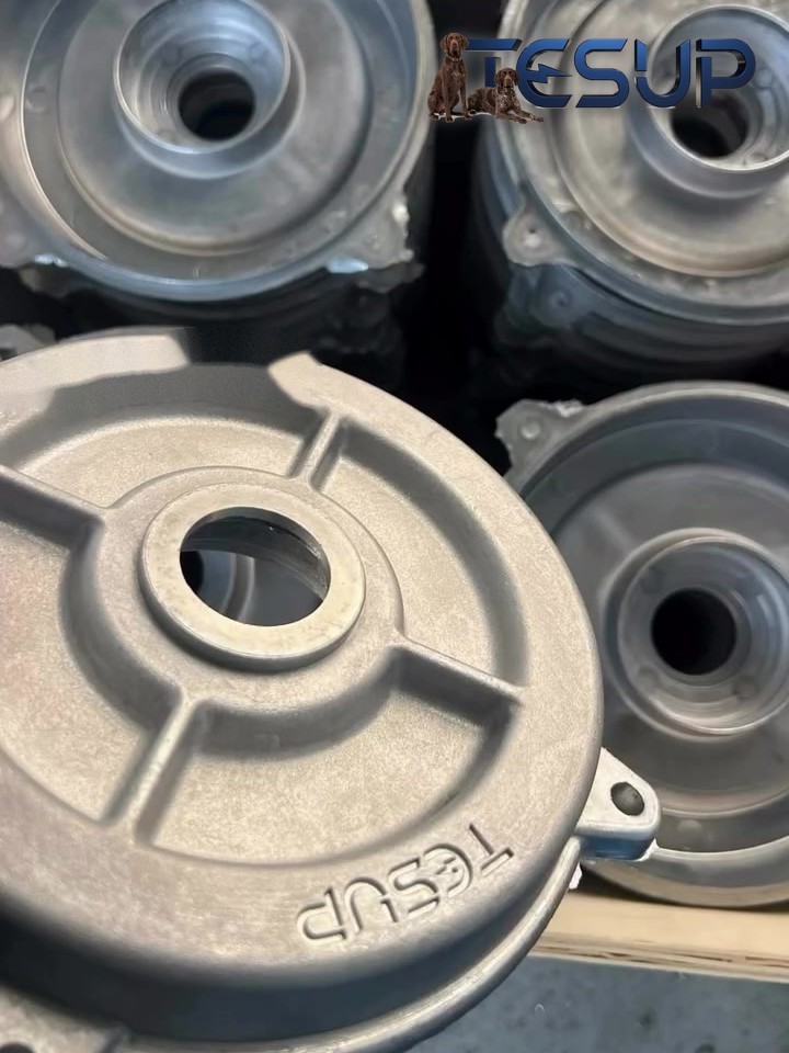 Finished aluminium motor covers with the TESUP name cast in, stacked after machining
