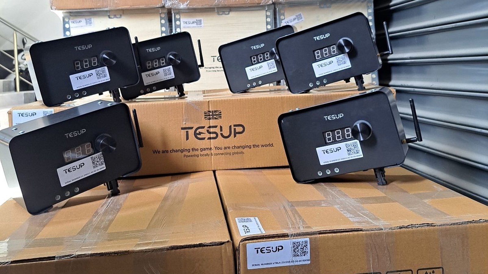 TESUP charge controllers with their display and dial, lined up on TESUP cartons in the warehouse