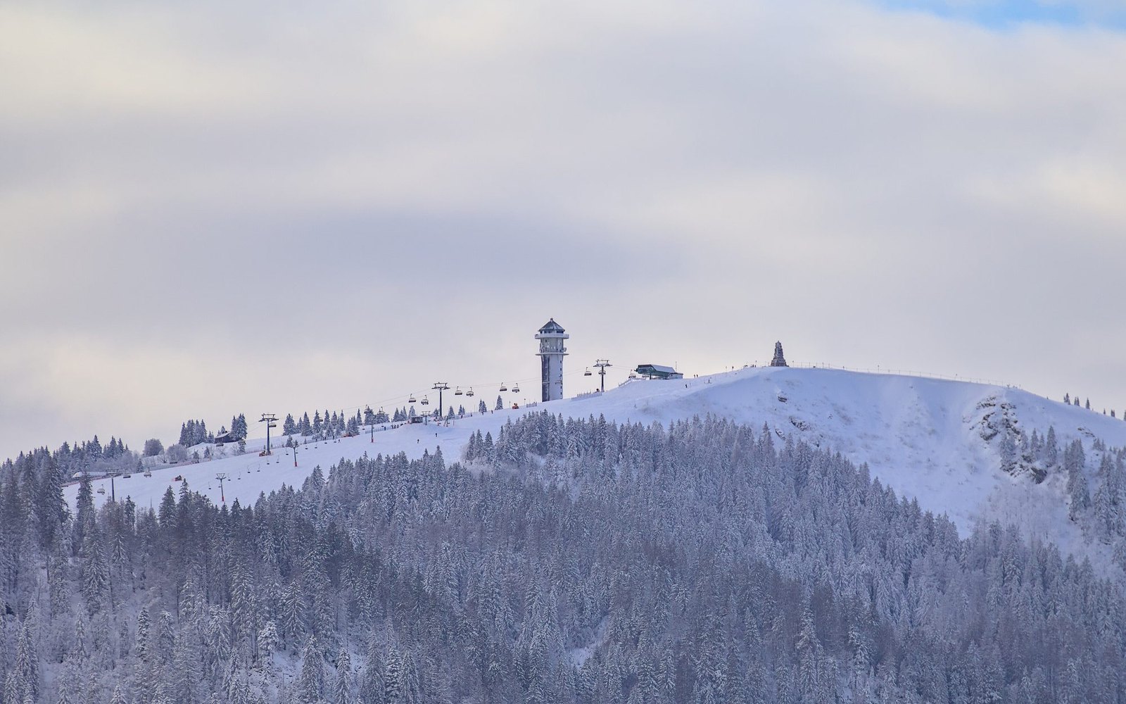 The snow-covered summit of the Feldberg in the Black Forest with its tower, seen from the east in winter