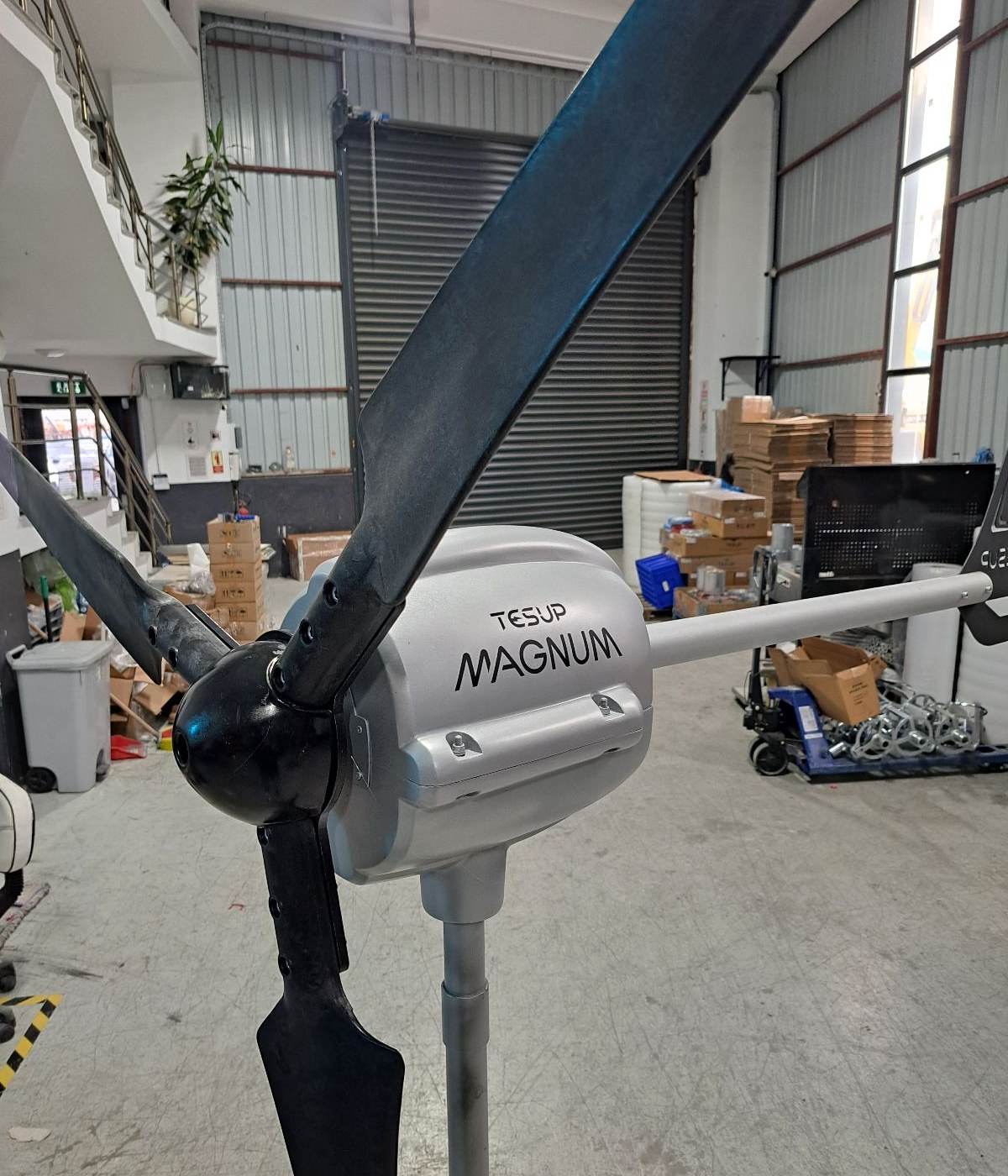 A TESUP Magnum horizontal wind turbine with black blades assembled in the warehouse