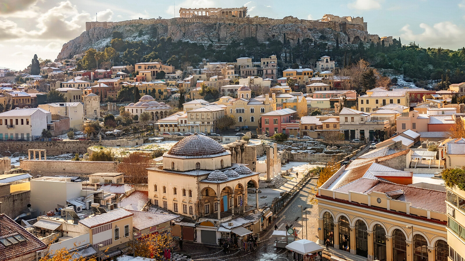 Athens under a light dusting of snow, seen across the rooftops towards the Acropolis